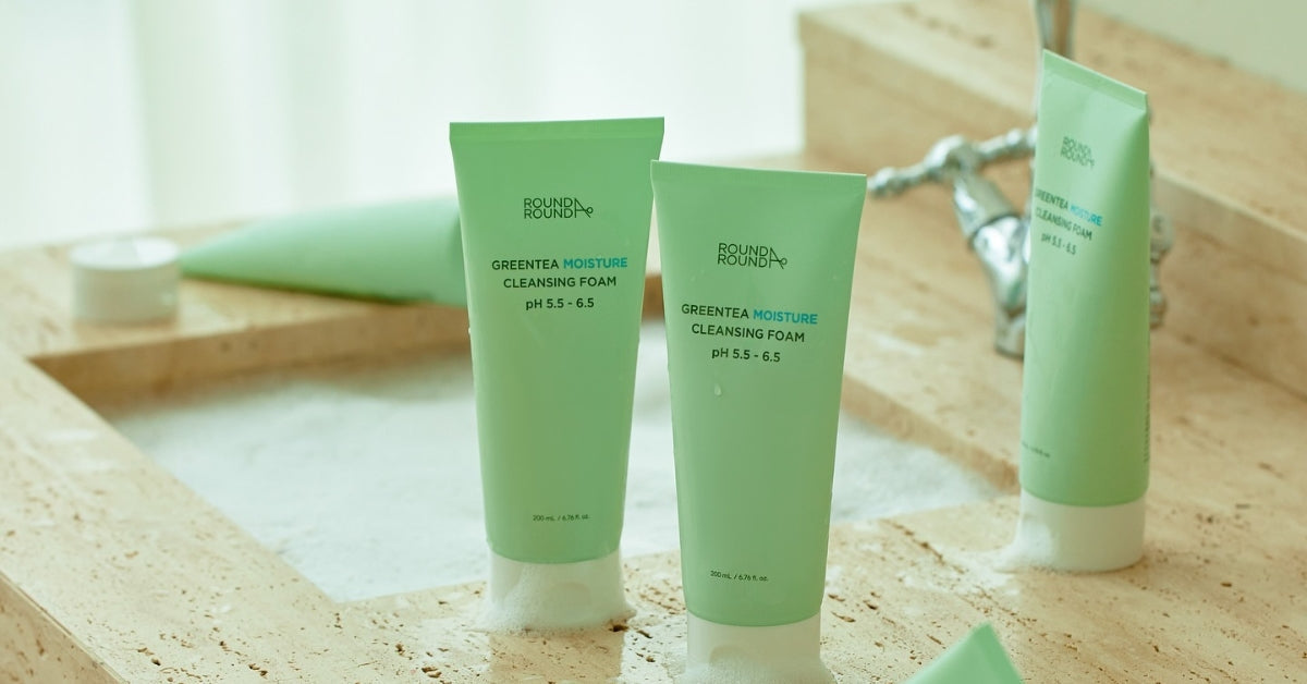 ROUND A'ROUND: Your Daily Dose of Fun and Effective Skincare Magic! Green Tea Cleansing Foam bottles on a spa countertop.