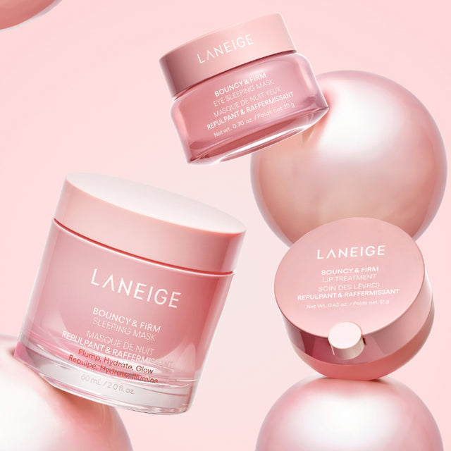 Laneige Bouncy & Firm Sleeping Mask and Eye Sleeping Mask on pink background with product jars and spheres.