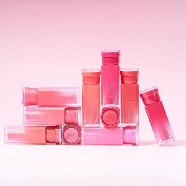 Assortment of 2an Glaze Bouncing Tint bottles arranged on a pink background, showcasing vibrant color options.