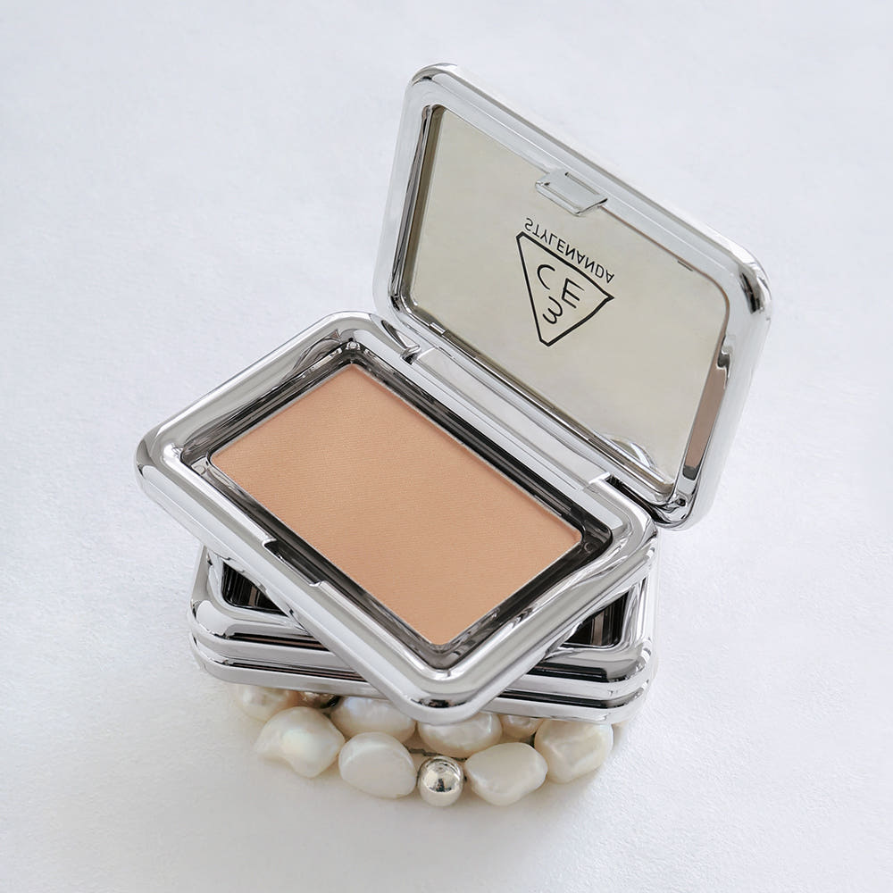 3CE New Take Face Blusher in sleek metallic compact, open to show peach shade against white background with decorative pearls.