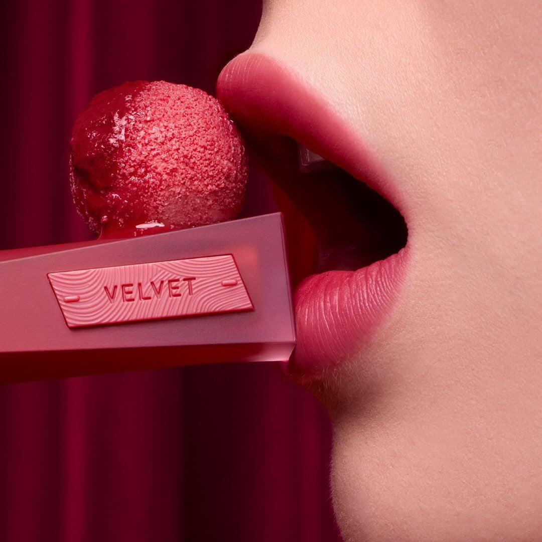 Close-up of model applying 3CE Velvet Lip Tint Plush for vibrant lip color
