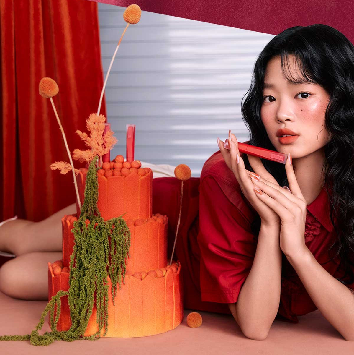 Model showcasing 3CE Velvet Lip Tint Plush with artistic floral background