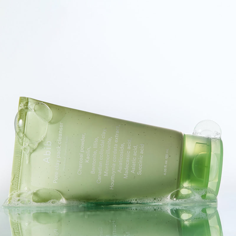 ABIB Pore Clay Pack Cleanser 120ml tube with bubbles on a reflective surface