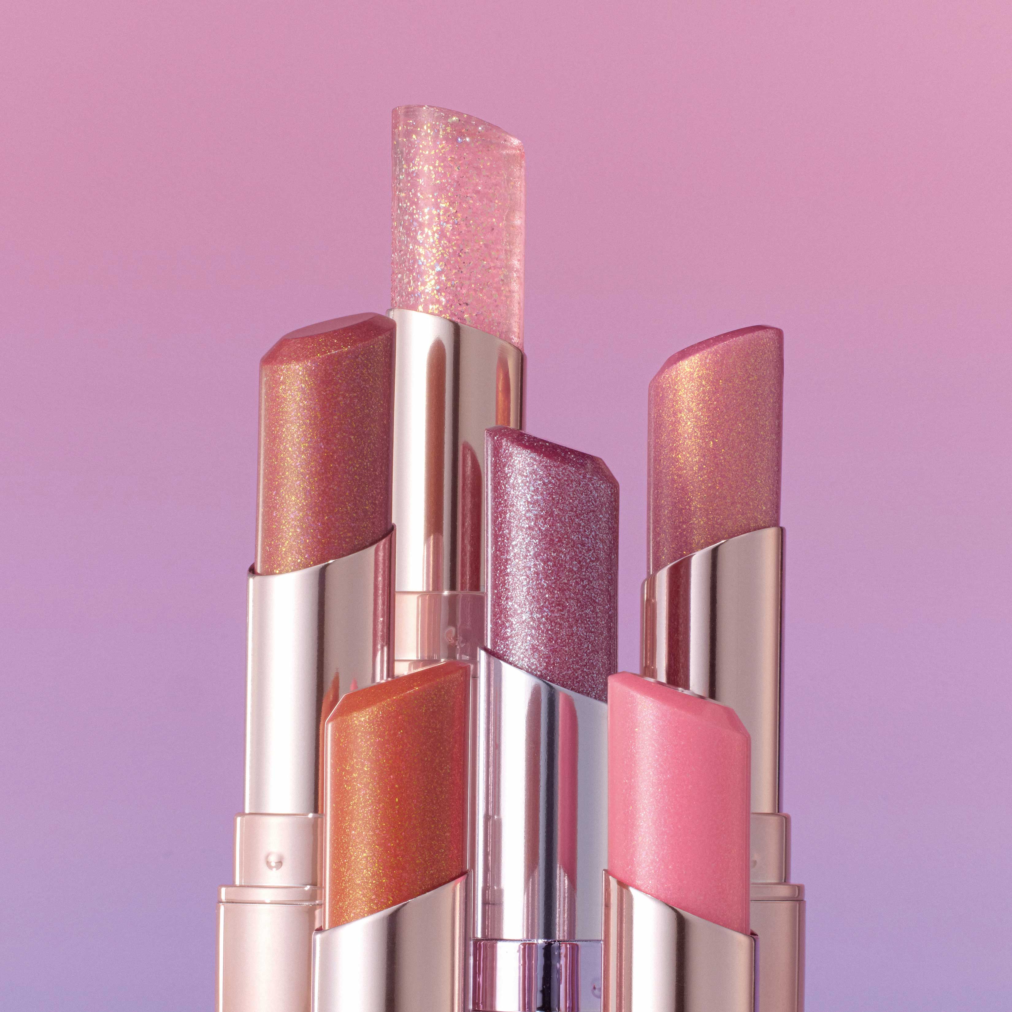 ALL MY THING I'm Your Lip Tint collection in various shades and shimmering finishes against a pink gradient background.