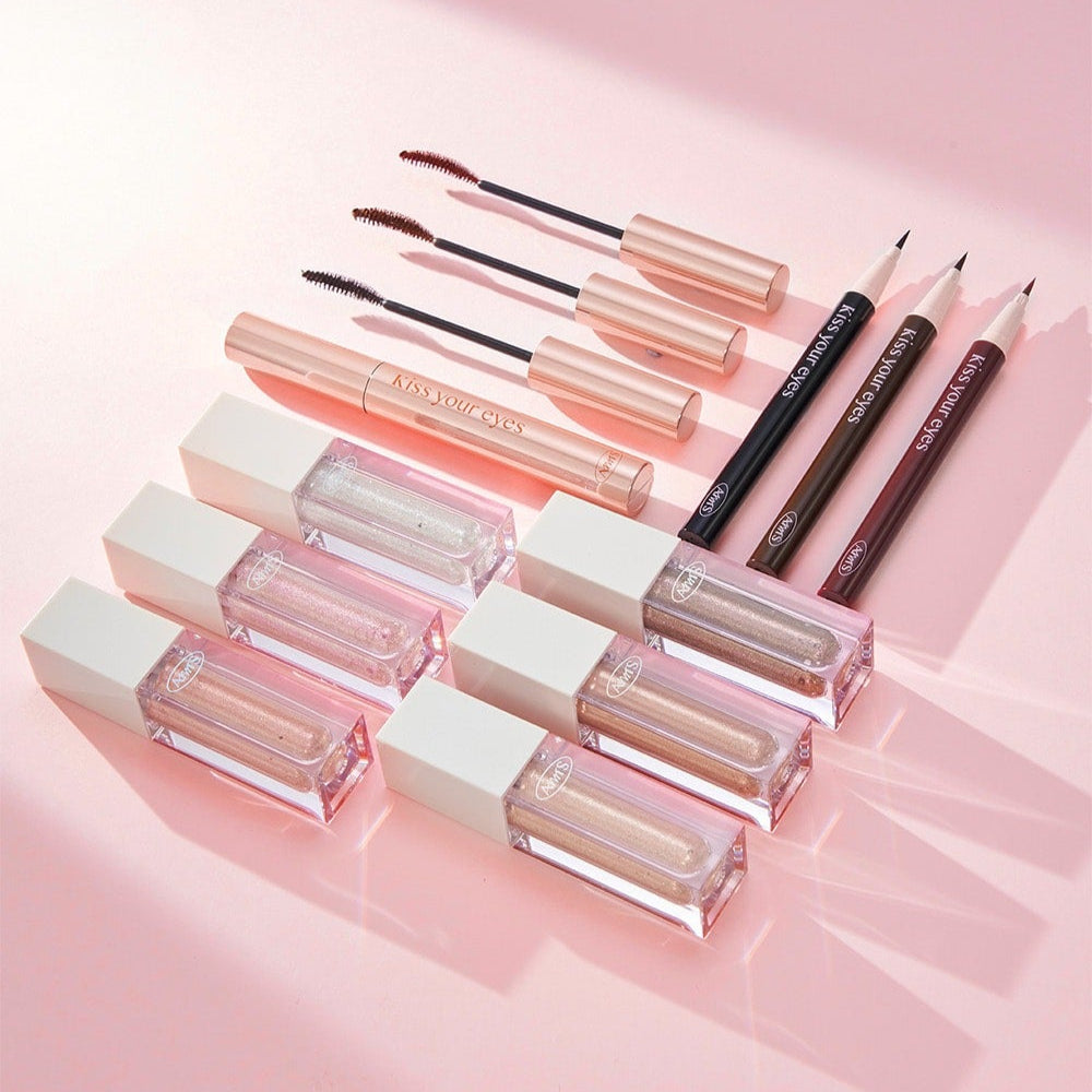 ALL MY THING Kiss Your Eye Glitter Liquid Eyeshadow collection with mascaras and eyeliners on a pink background