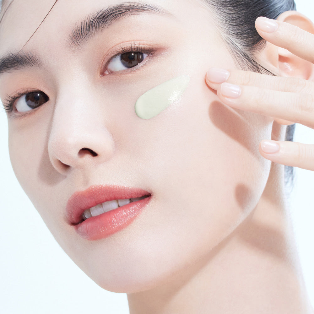 Woman applying AMELI Complement Series Charok Filter 50ml on face