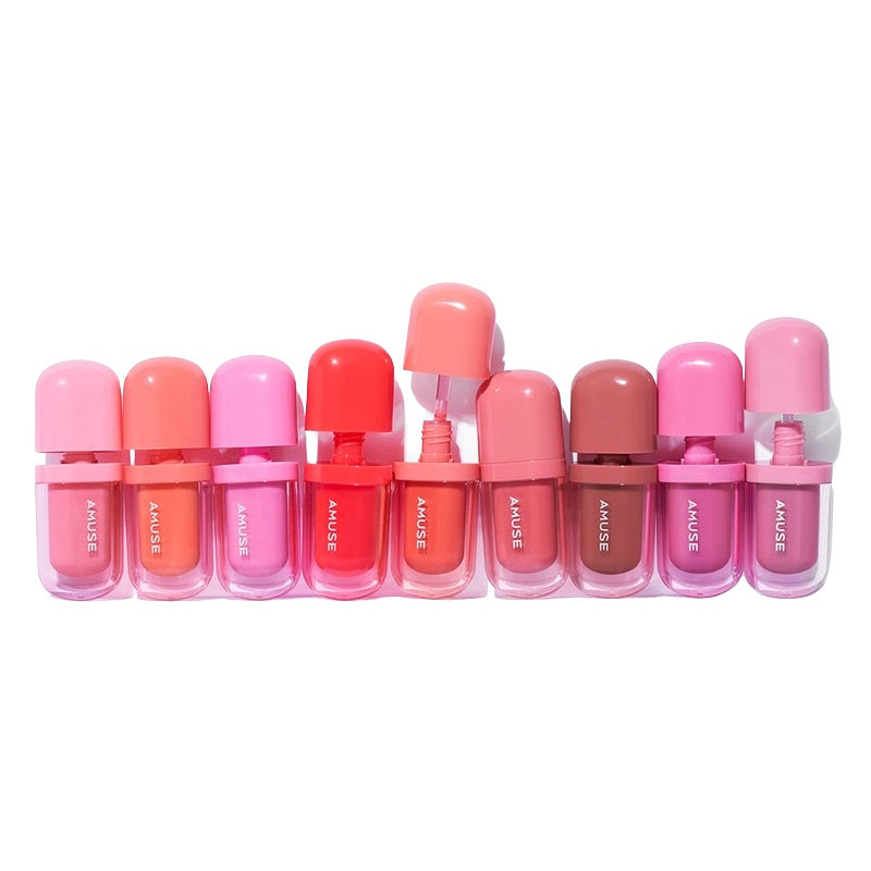 Colorful selection of AMUSE BEBE TINT lip products in various shades, beautifully arranged in a row.