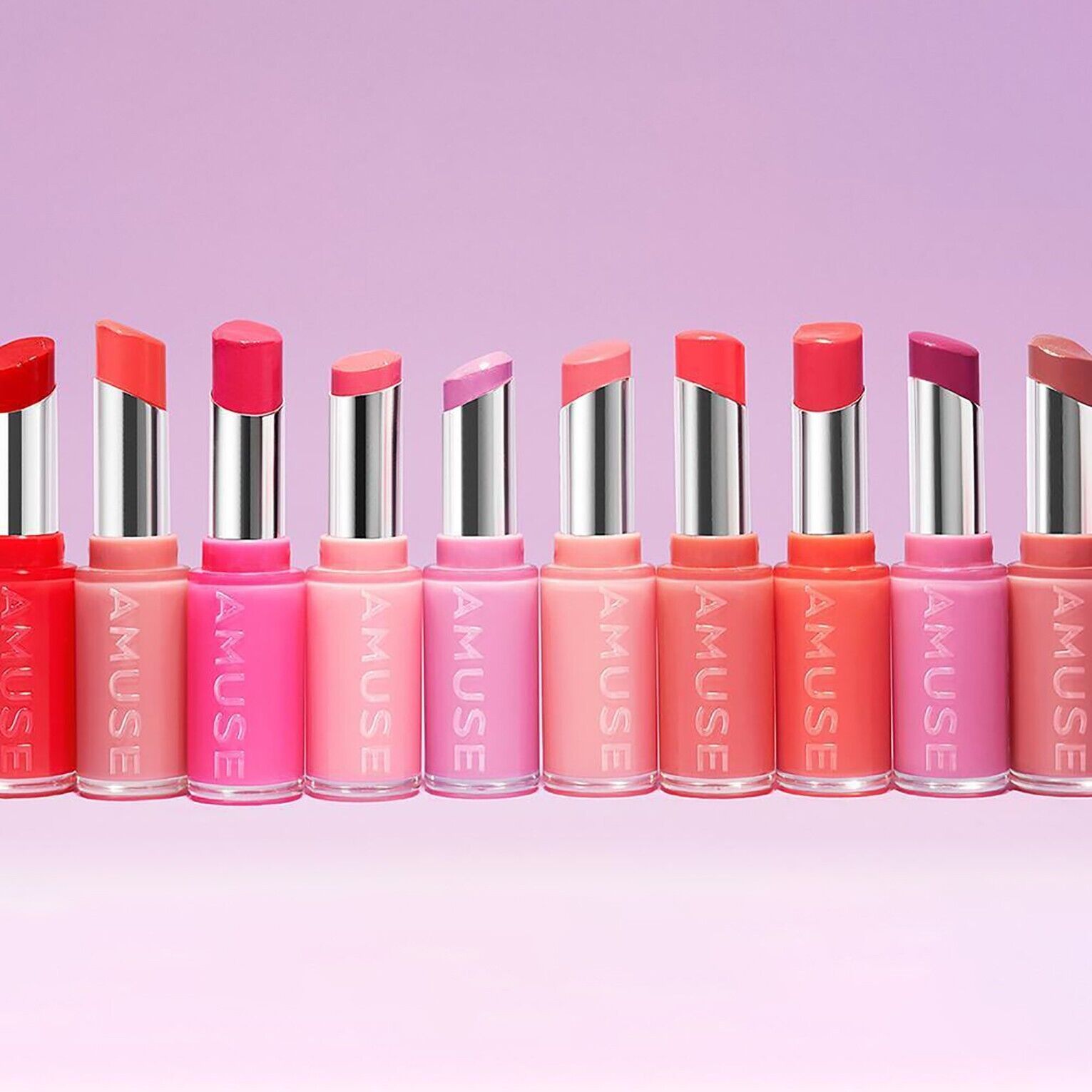 AMUSE Fondue Balm collection in vibrant shades on a pastel background