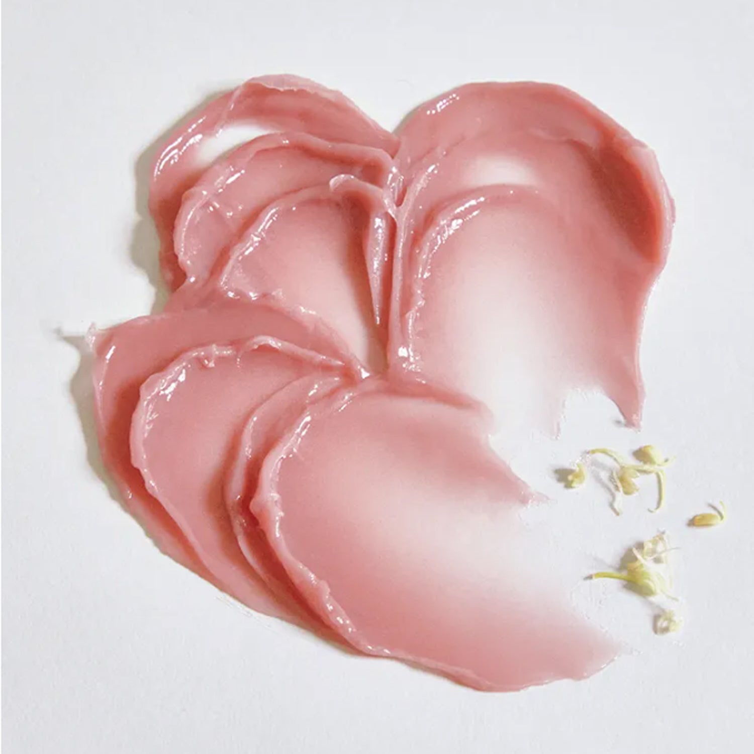 Swatch of ANILLO Rose Glow Balm on a white surface, showcasing its creamy, pink texture and smooth consistency.