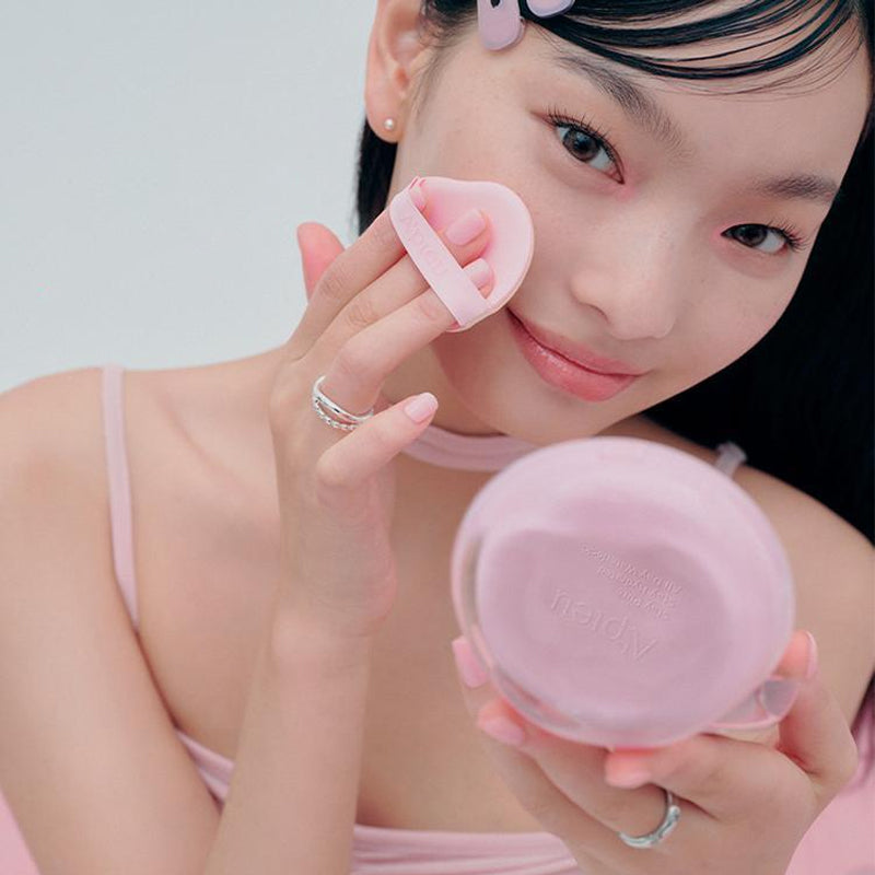 Person applying A'PIEU Waterlock Comfort Veil Cushion 15g with a puff on face.