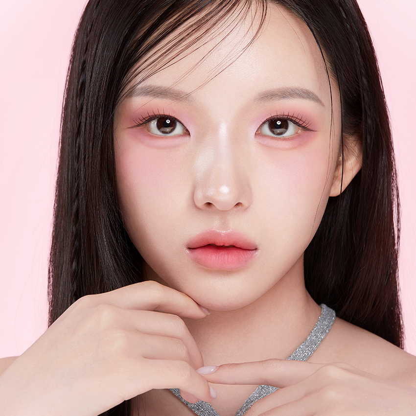 Portrait of a person with pink eyeshadow and smooth skin, illustrating the effects of APRILSKIN Slide Pocket Single Shadow.