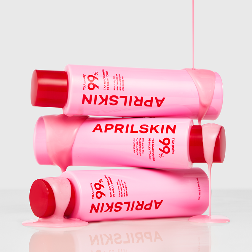 APRILSKIN TXA Niacinamide 99 Milky Toner 150ml bottles with pink liquid flowing over them