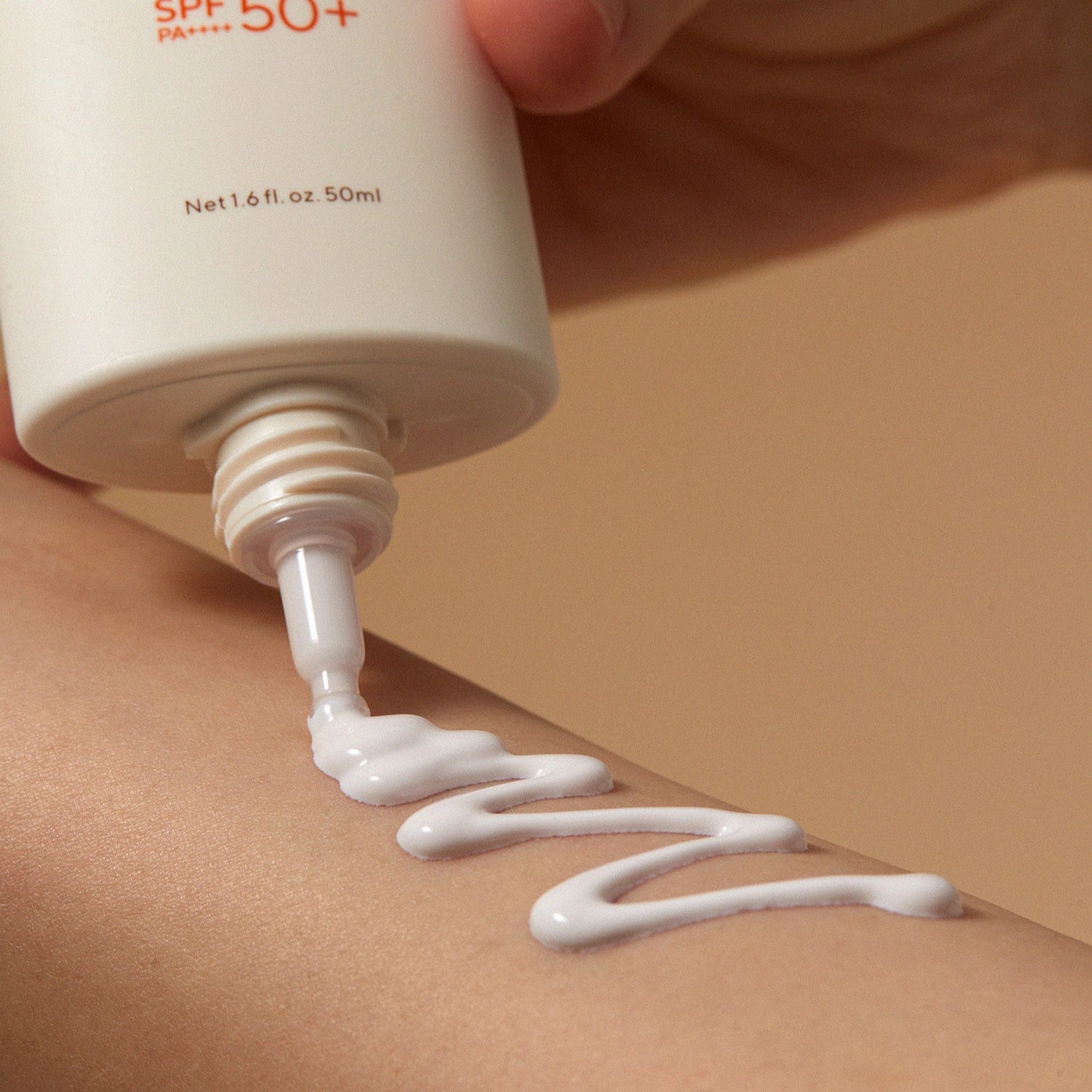 AROMATICA Vitalizing Rosemary Moisture Barrier Sunscreen 50ML being applied to skin, showing texture and SPF 50+ protection