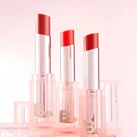 Three tubes of BANILA CO Glow Veil Lipstick in a radiant pink setting