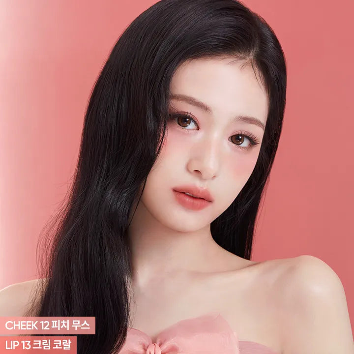 Woman wearing BANILA CO Romantic Blush Lip & Cheek in a soft pink shade.