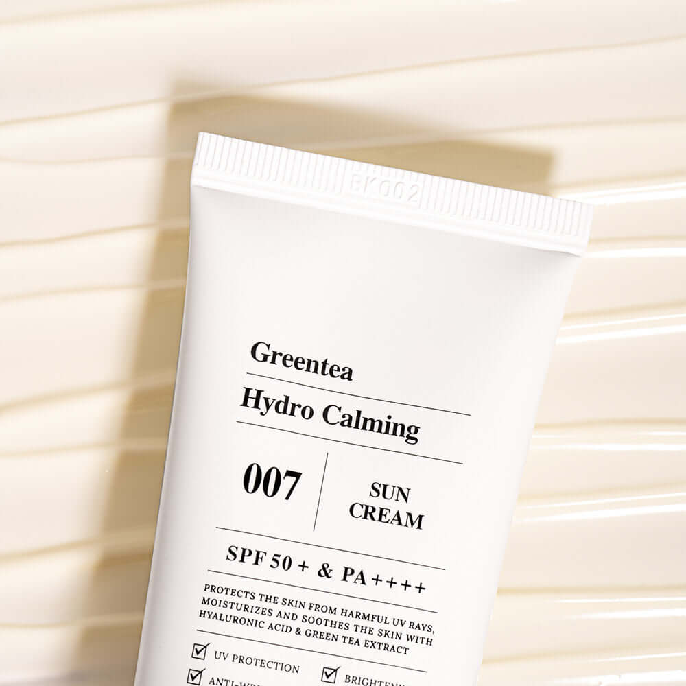 BARULAB Green Tea Hydro Calming Sun Cream tube showing SPF 50+ protection on a textured background.