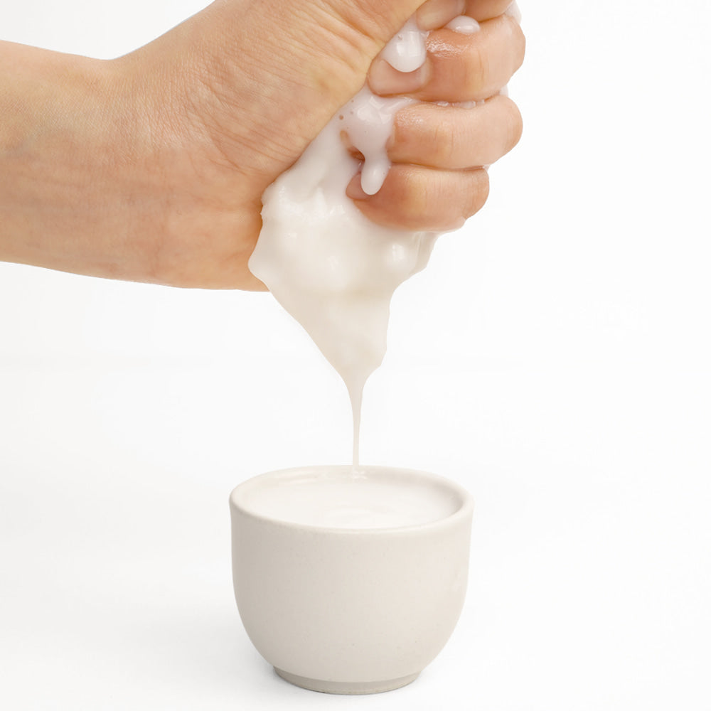 BARULAB Rice Makgeolli Probiotic Yeast Cream In Mask 5 Sheets being squeezed into a white cup.