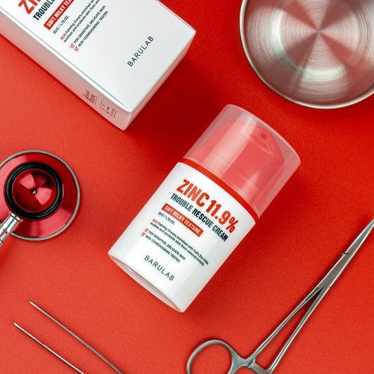 BARULAB Zinc 11.9 Percent Trouble Rescue Cream on a red background with medical tools for skincare.