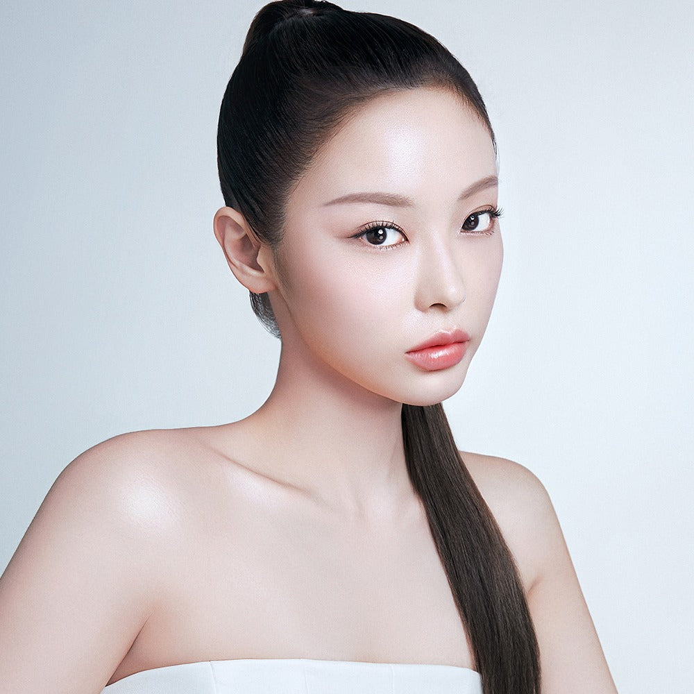 Model wearing BBIA Oh Powder Pact with flawless skin and sleek hairstyle