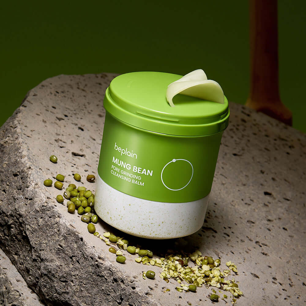 BEPLAIN Green Bean Pore Grinding Cleansing Balm on rocky surface with green beans