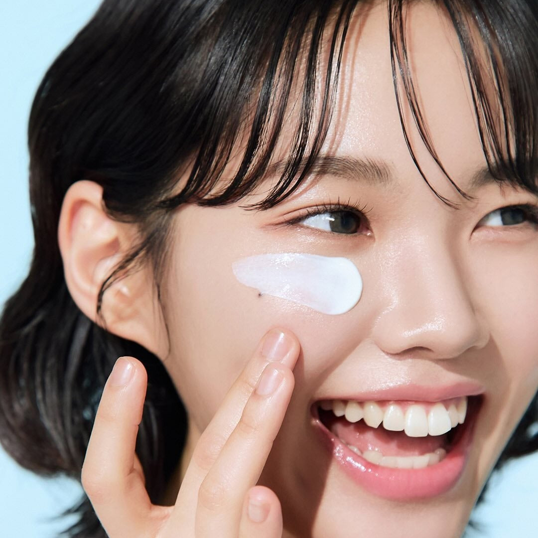 Woman applying BEPLAIN Lemon Seed Glutathione Tone-up Sun Cream 50ml for radiant skin protection