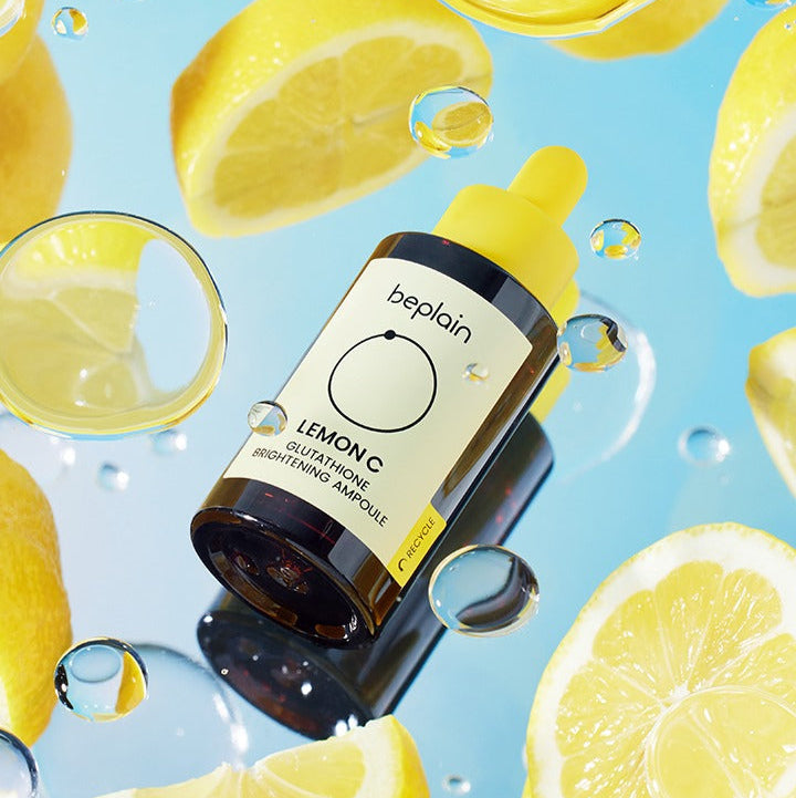 BEPLAIN Lemon Seed Glutathione Whitenning Ampoule 30ml surrounded by fresh lemon slices and water droplets