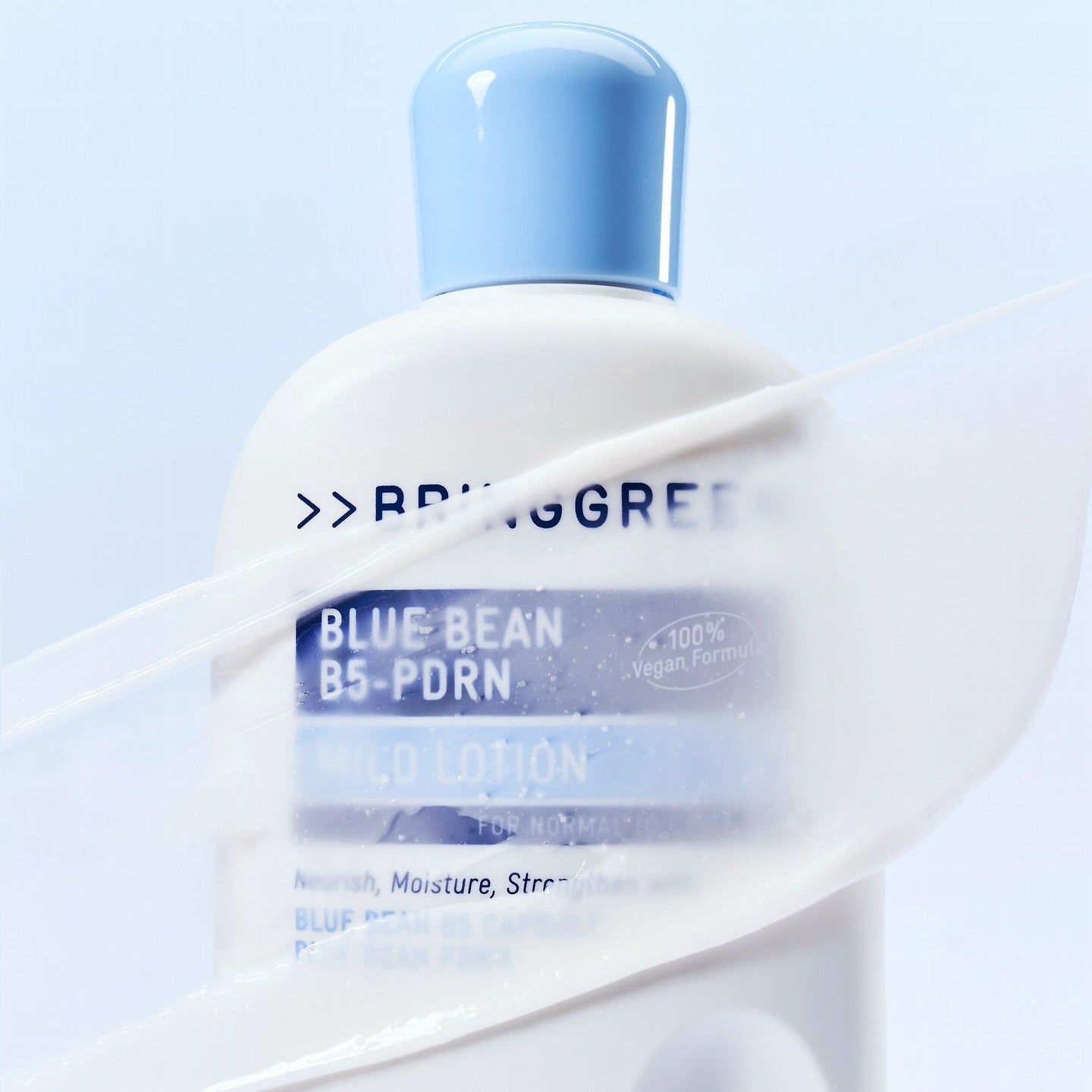 BRINGGREEN Blue Bean B5-PDRN Mild Lotion 230ml bottle with a light blue cap against a soft background.