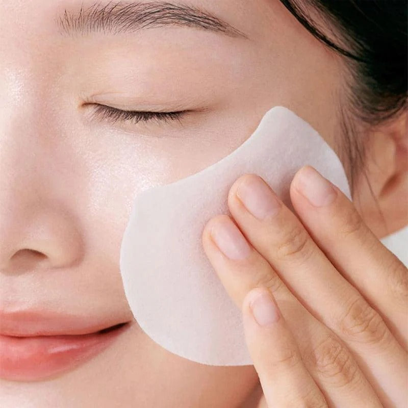 Woman using CELIMAX Pore Dark Spot Brightening Pad 40ea on face for skincare routine
