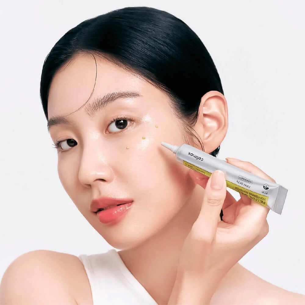 Woman applying CELIMAX Retinol Shot Tightening Booster 15ml to face for skincare