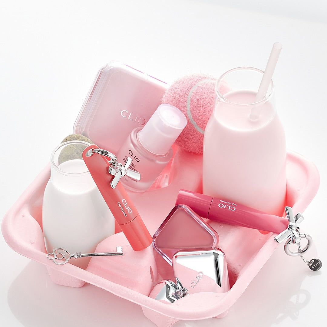 Tray with CLIO Glazing Prep Base 40ml surrounded by beauty products, emphasizing skincare essentials.