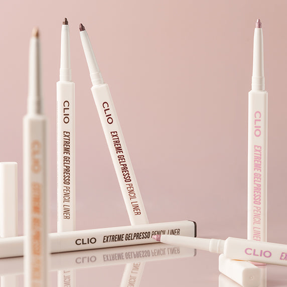CLIO NEW Extreme Gelpresso Pencil Liner displayed on a soft pink background, showcasing various shades of eyeliner pencils.
