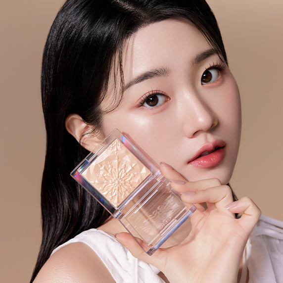 Model showcasing CLIO Prism Highlighter makeup product, enhancing her natural glow with radiant shimmer.