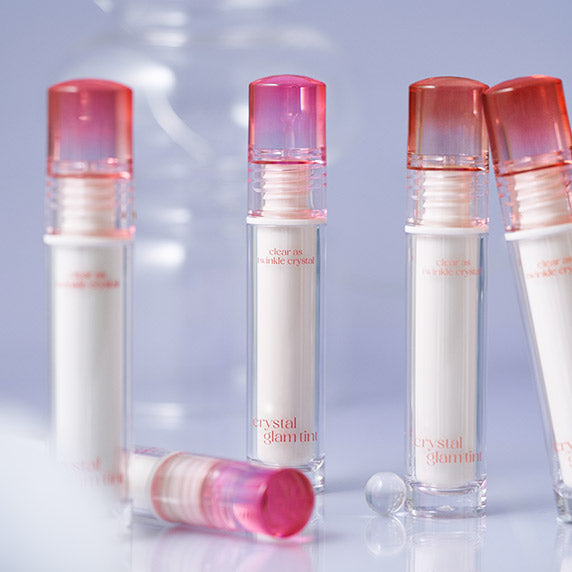 CLIO Crystal Glam Tint in sleek transparent bottles with pink caps, perfect for adding a touch of glamour to your makeup collection.