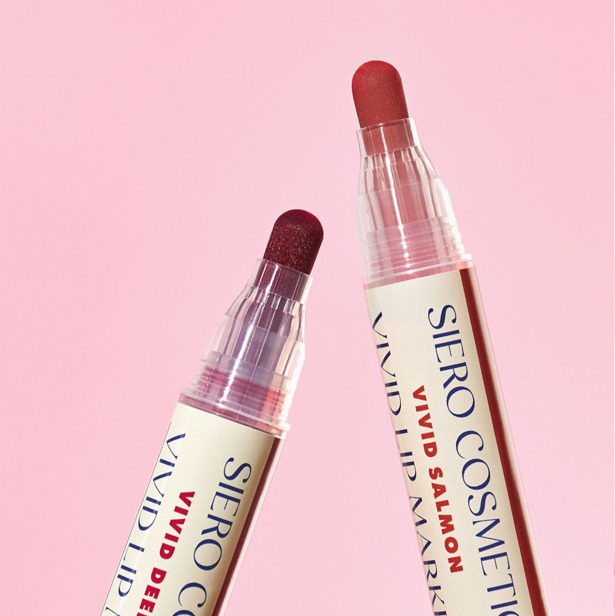 Two shades of COSIERO Vivid Lip Marker against pink background.