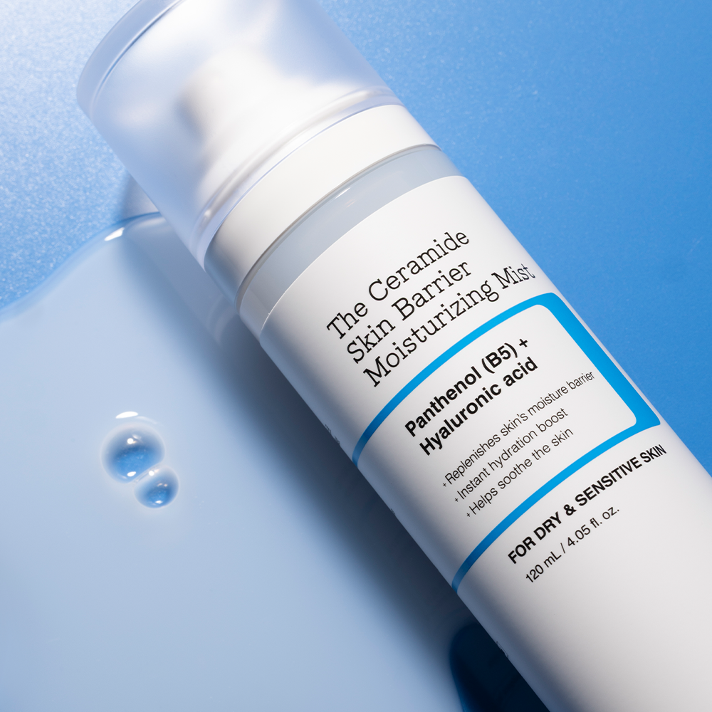 Bottle of COSRX The Ceramide Skin Barrier Moisturizing Mist 120ml on a blue background with product details visible.