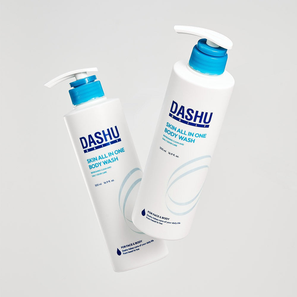 Two bottles of DASHU Daily Skin All-in-One Body Wash 500ml with blue caps standing against a light background.
