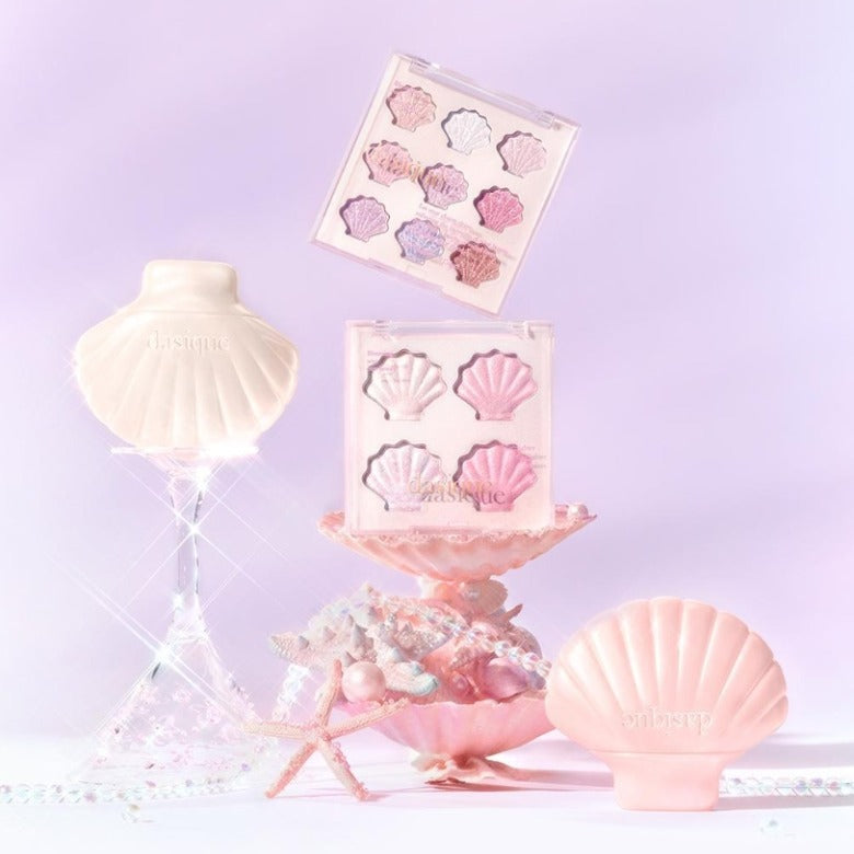 DASIQUE Shine Glowy Highlighter Palette with shell-themed packaging on a pastel background