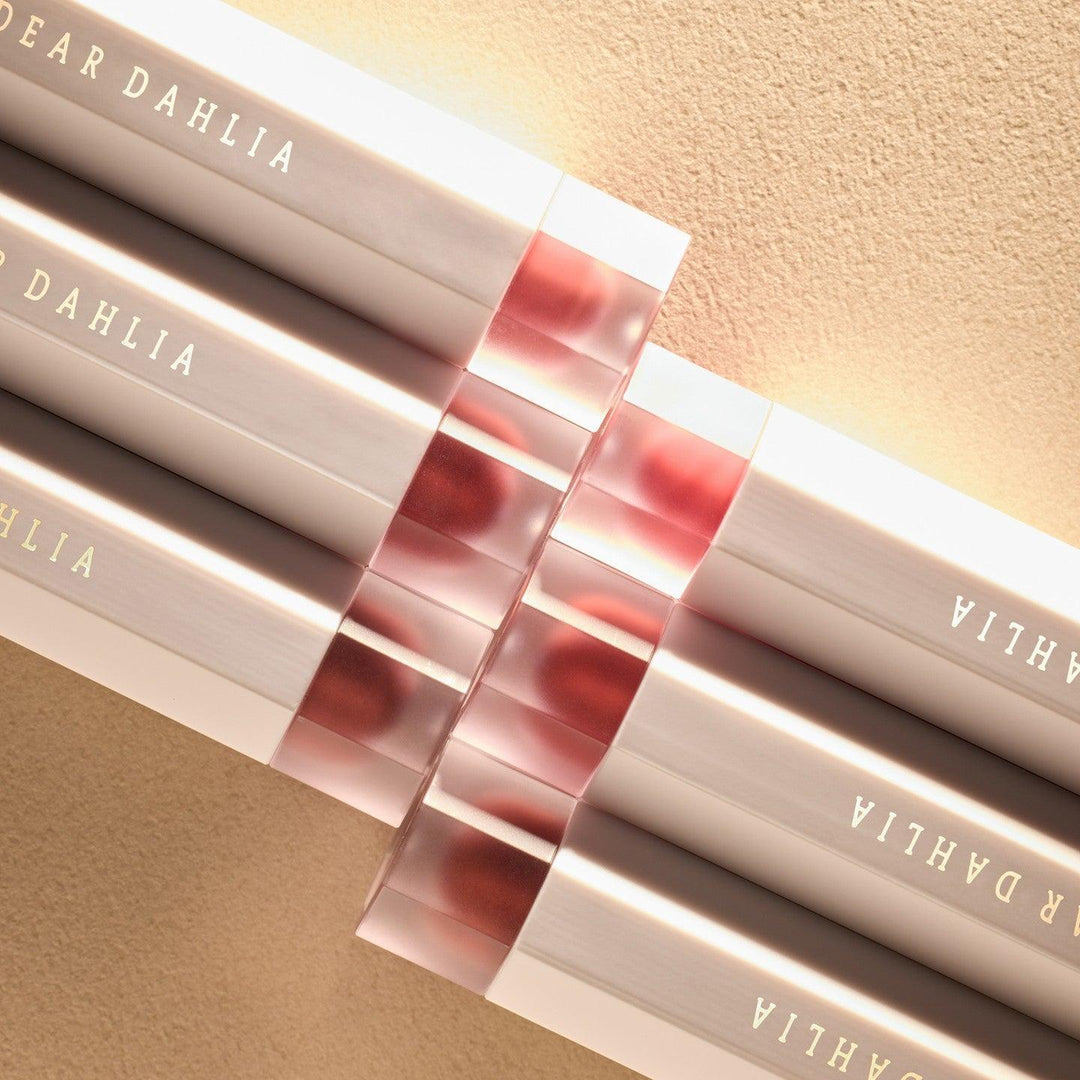 DEAR DAHLIA Dream velvet Lip Cloud lipsticks arranged in a row on a soft beige background