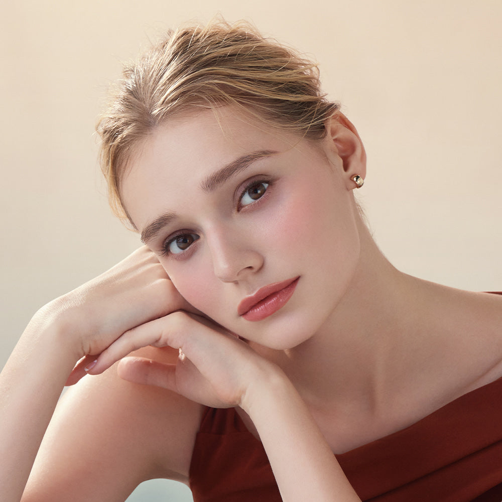 Model wearing DEAR DAHLIA Lip Paradise Sheer Dew Lipstick with soft makeup look