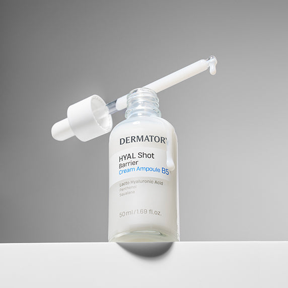 Open bottle of DERMATORY Hyal Shot Barrier Cream Ampoule B5 50ml with dropper on gray background.