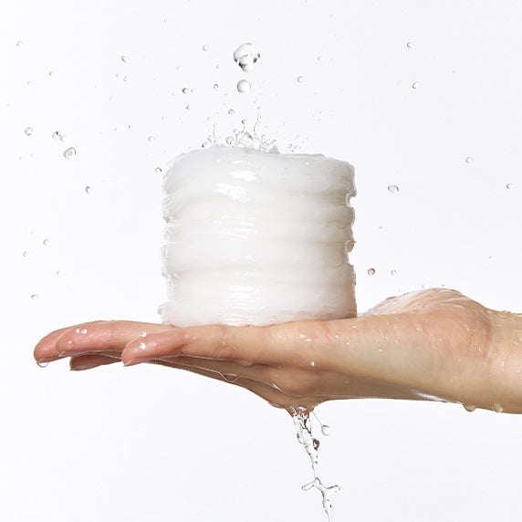 DERMATORY Hyaluronic Acid Moisture Spring Embo Pad Refill 60 sheets in hand with water droplets