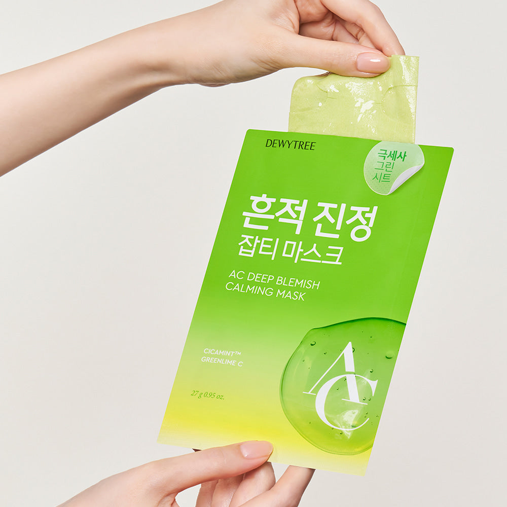Close-up of DEWYTREE AC Deep Blemish Calming Mask 10 Sheets package held by a hand, displaying the green packaging and mask sheet.