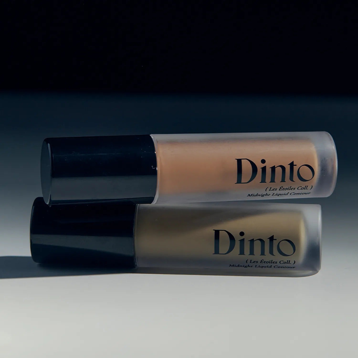 Two bottles of DINTO Midnight Liquid Contour 2 Types on a dark background.