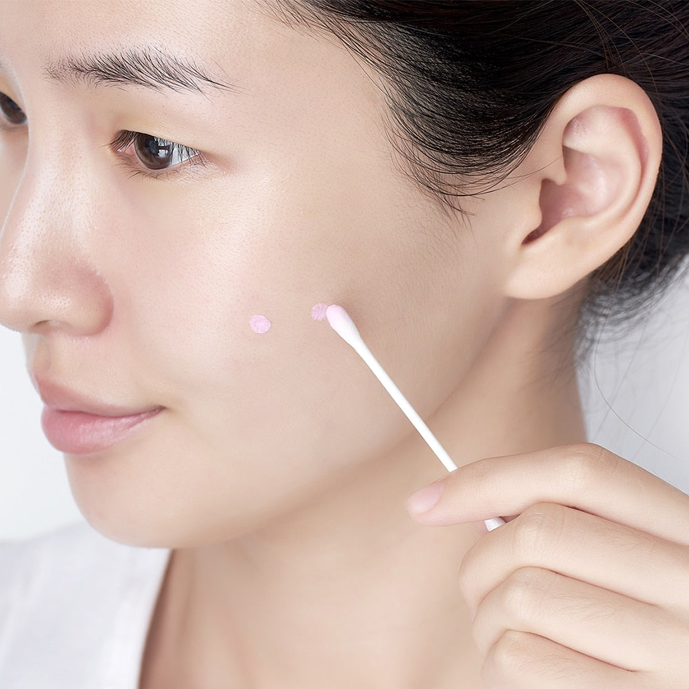 Applying DR. JART+ Ctrl-A Teatreement Soothing Spot 15ml with cotton swab to face for targeted skincare treatment