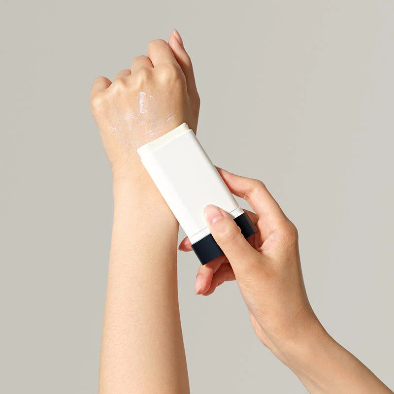 Applying DR.CEURACLE Pro Balance Comfort Sun Stick 18g on arm for sun protection