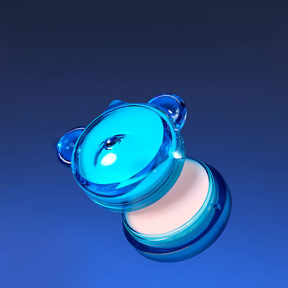 Bright blue container of DR.JART+ Vital Hydra Solutionâ„¢ Hydrating Lip Mask against a dark gradient background