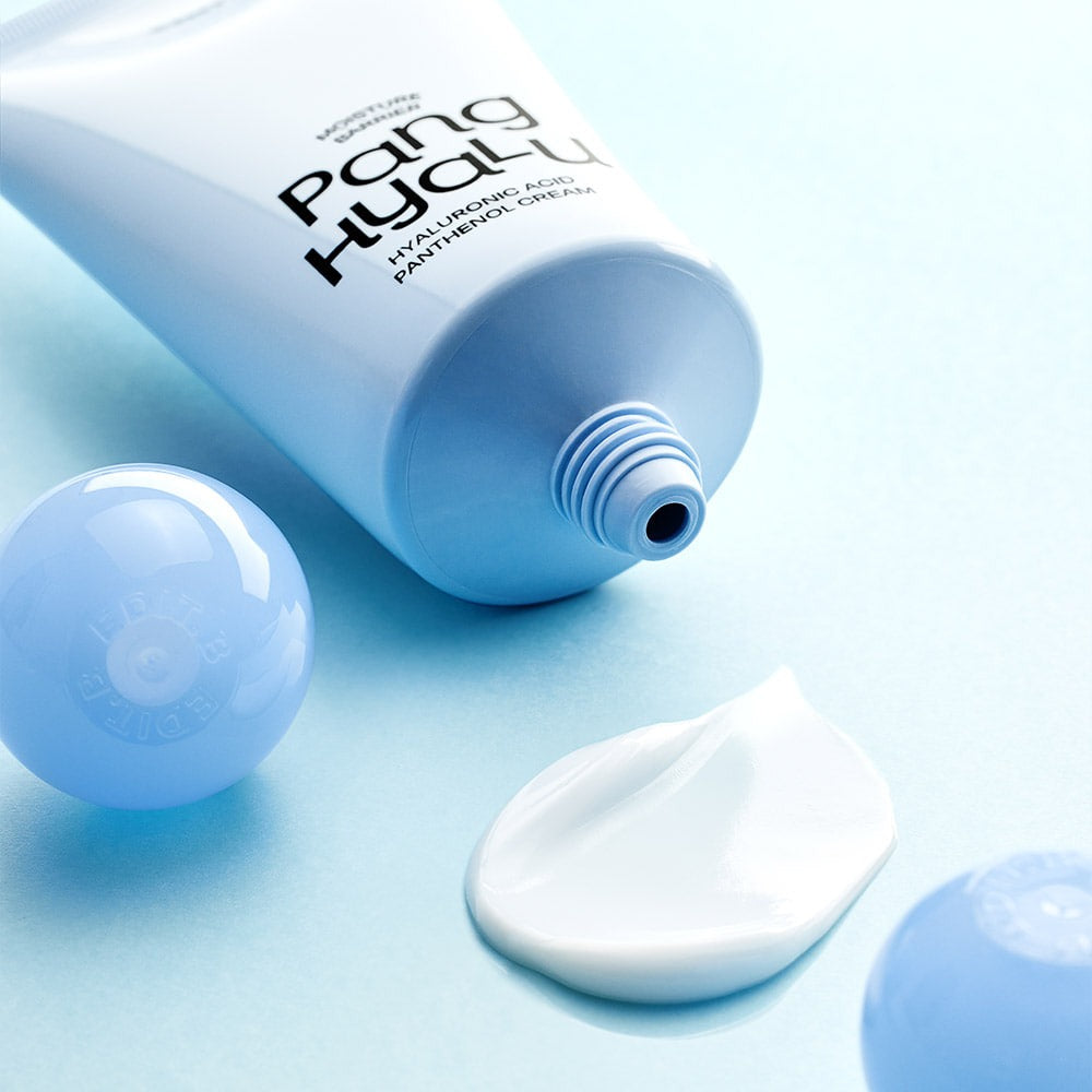 EDIT.B Moisture Barrier Pang Hyaluronic Acid Pathenol Cream 100ml tube and cream texture on a blue background.