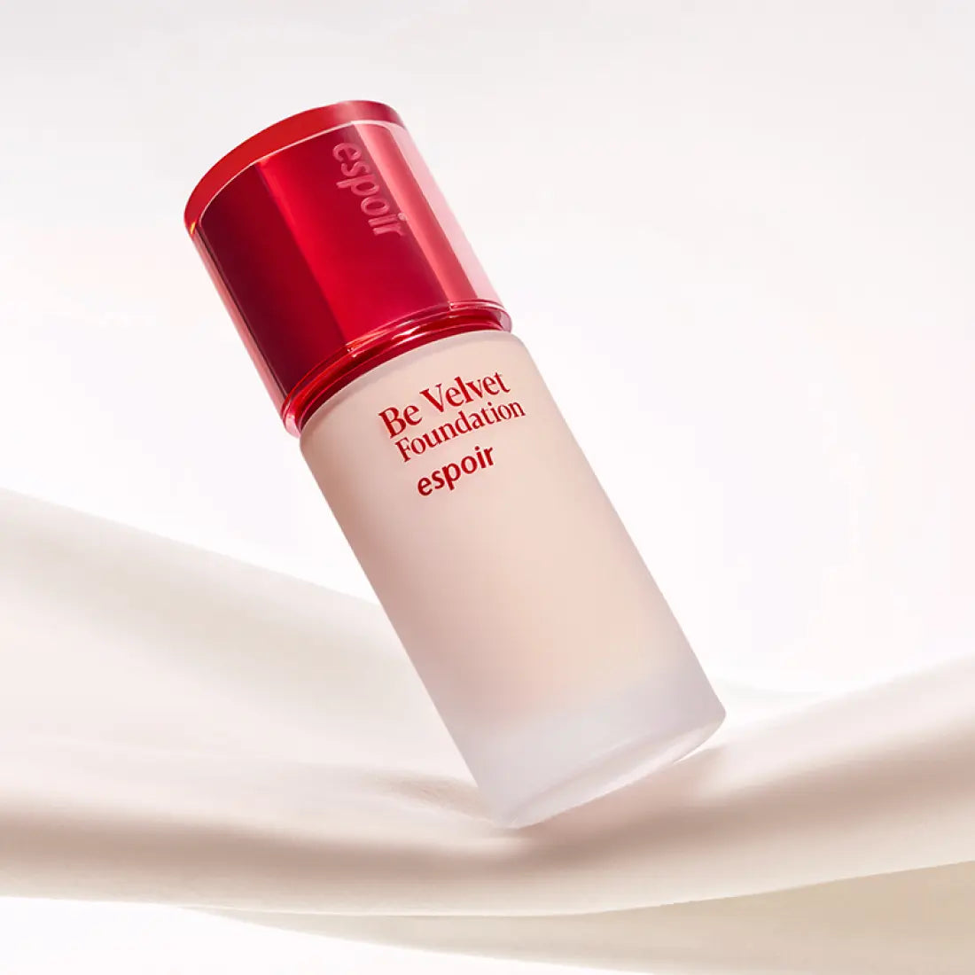 ESPOIR BE VELVET FOUNDATION SPF22 PA++ bottle on a silky fabric background