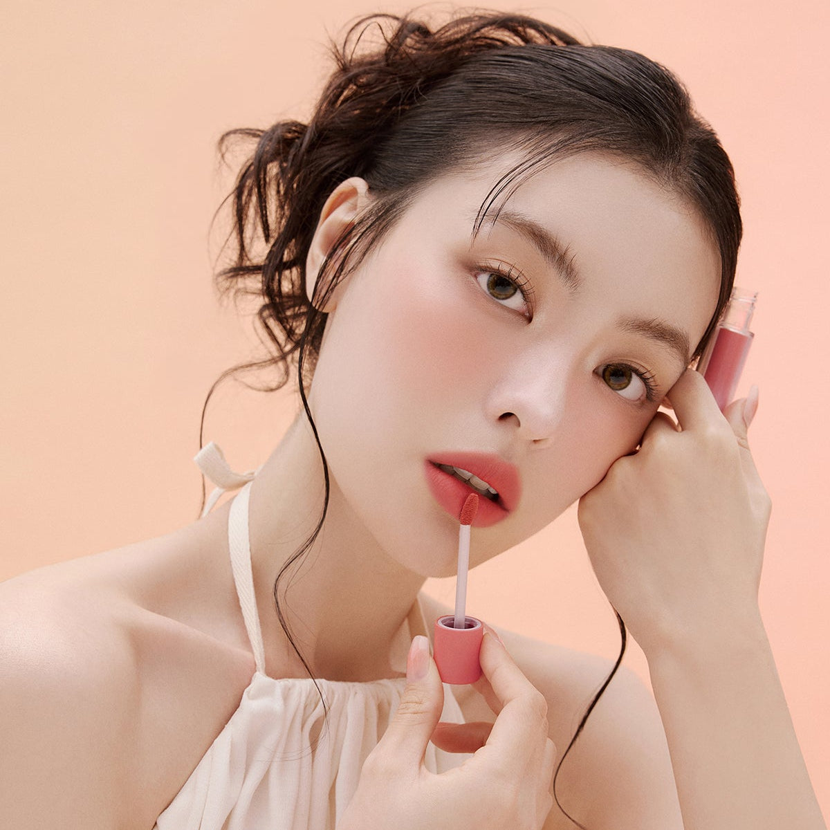 Woman applying ESPOIR Couture Lip Tint Fitting Blur for a natural, soft look.