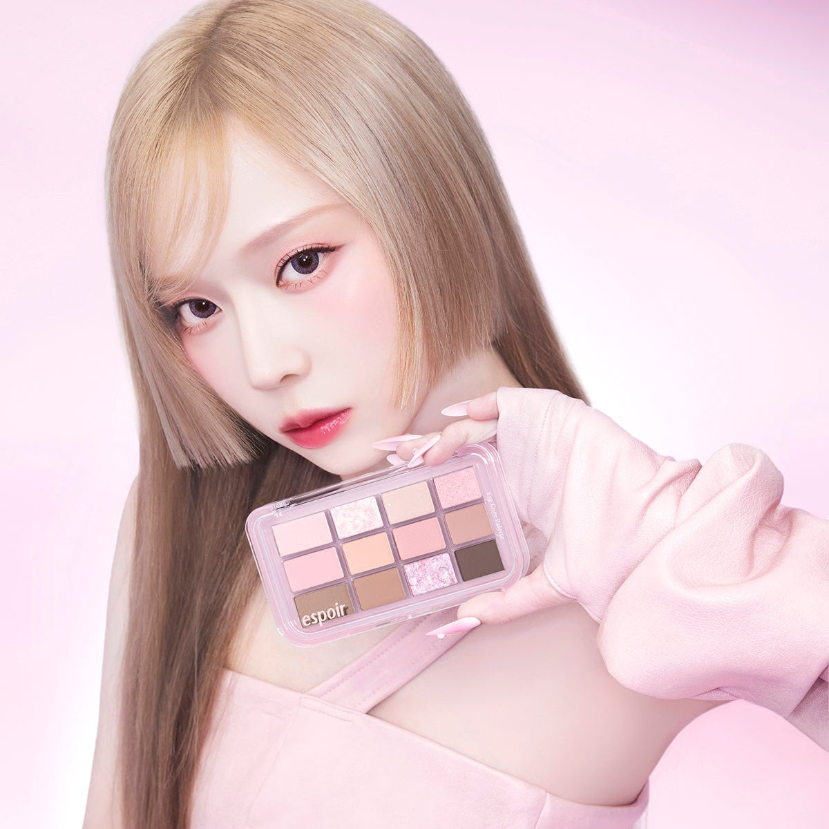 Model holding ESPOIR Eye Core Palette showcasing vibrant eyeshadow colors.